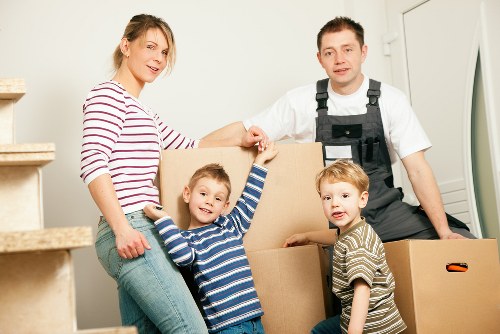 Man and van removals team loading furniture for a local move in France